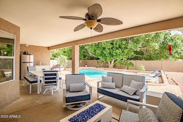 2405 E Lynwood Cir, Mesa, AZ 85213 - fenced backyard with an outdoor living space with a fire pit, a patio area, outdoor dining area, and a ceiling fan