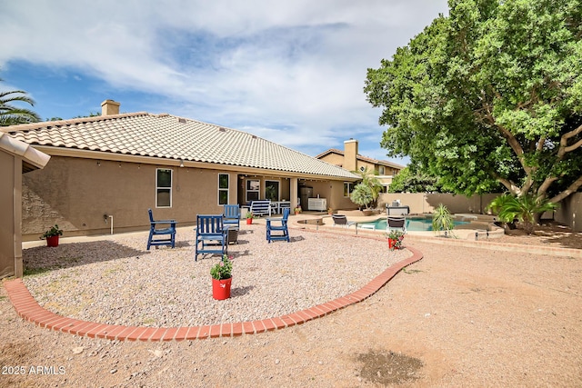 2405 E Lynwood Cir, Mesa, AZ 85213 - rear view of house with a tile roof, stucco siding, a chimney, a fenced backyard, and a patio