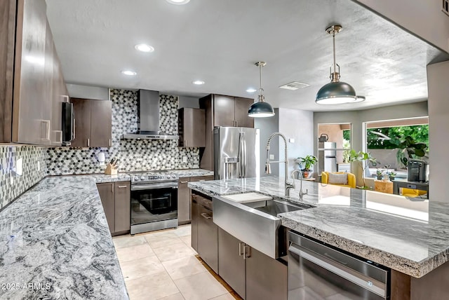 2405 E Lynwood Cir, Mesa, AZ 85213 - kitchen with appliances with stainless steel finishes, wall chimney exhaust hood, a sink, tasteful backsplash, and dark brown cabinetry