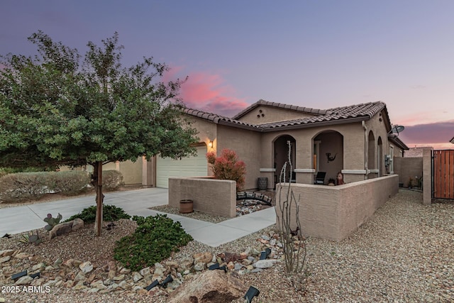 mediterranean / spanish-style home with a garage