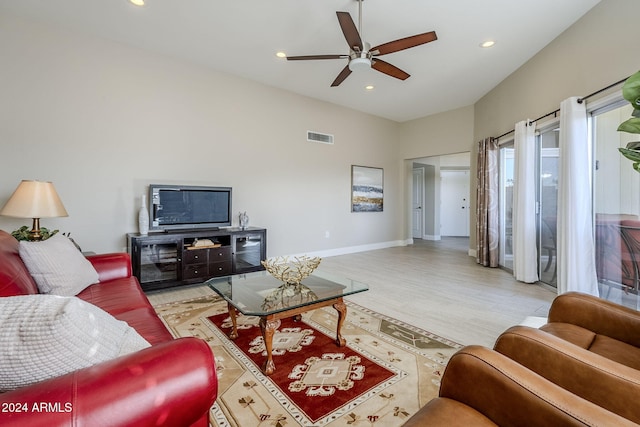 living room featuring ceiling fan and light hardwood / wood-style flooring