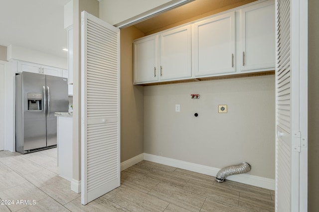 washroom featuring hookup for an electric dryer and cabinets