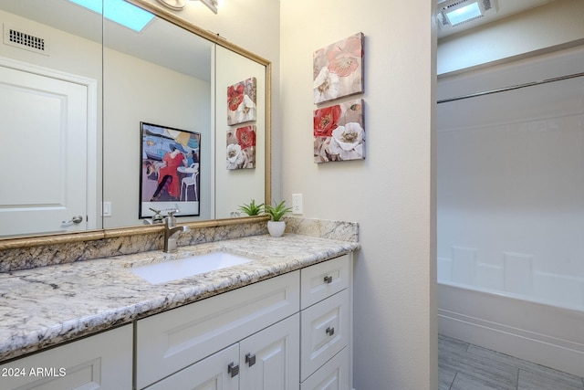 bathroom with vanity and bathing tub / shower combination