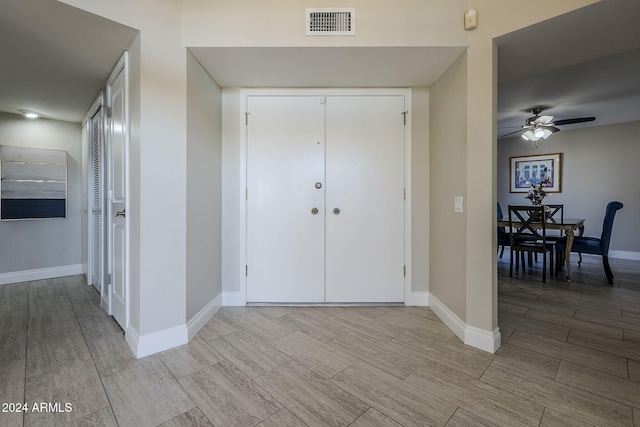 foyer featuring light hardwood / wood-style floors and ceiling fan