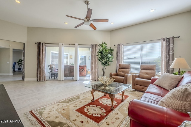 living room featuring ceiling fan, plenty of natural light, and light hardwood / wood-style flooring