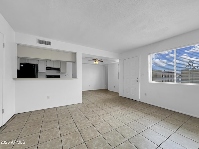 4416 E Riverside St, Phoenix, AZ 85040 - unfurnished living room featuring ceiling fan, a textured ceiling, and light tile patterned floors