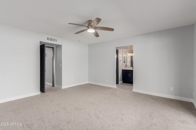 unfurnished bedroom with light carpet, ensuite bath, and ceiling fan