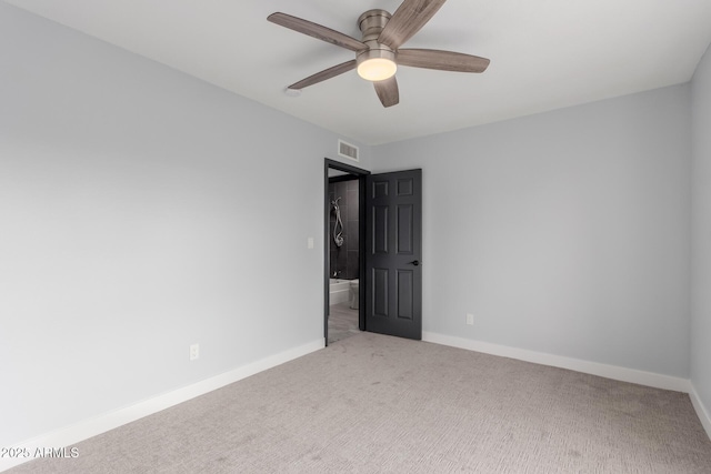 empty room featuring ceiling fan and light colored carpet