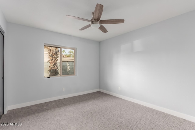 carpeted empty room featuring ceiling fan