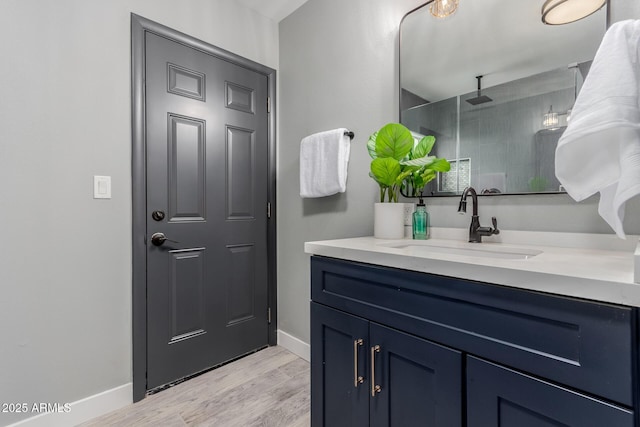 bathroom featuring vanity, hardwood / wood-style floors, and a shower with door