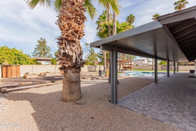 exterior space with a fenced in pool and a patio