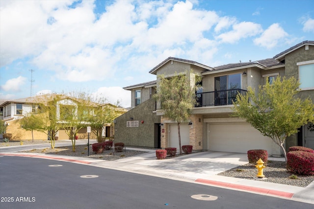 view of front of house featuring a garage and a balcony