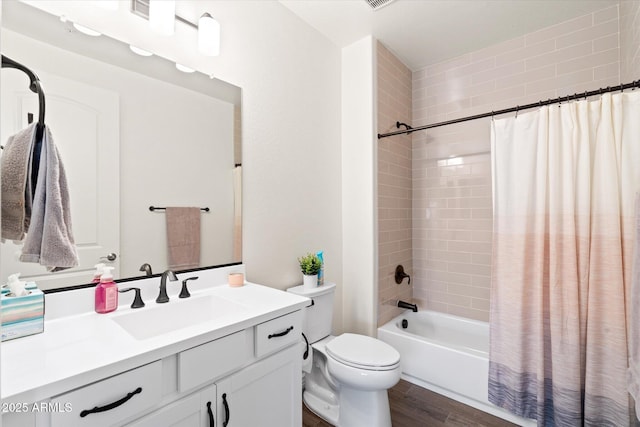 full bathroom featuring vanity, hardwood / wood-style flooring, toilet, and shower / bath combo