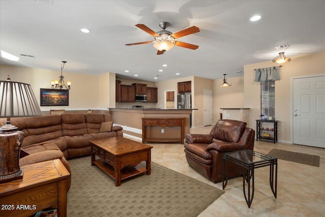 tiled living room featuring ceiling fan with notable chandelier