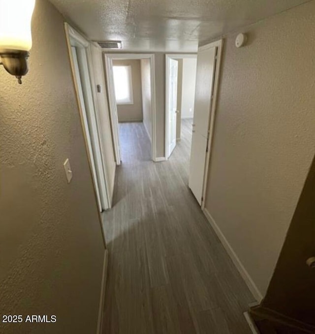 5420 W Lynwood St, Phoenix, AZ 85043 - hall with baseboards, wood finished floors, a textured ceiling, and a textured wall