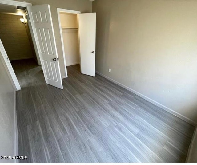 5420 W Lynwood St, Phoenix, AZ 85043 - unfurnished bedroom featuring a closet, baseboards, and wood finished floors