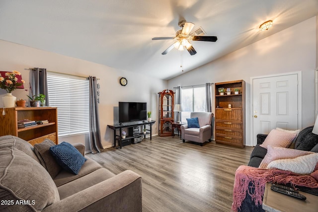 living room with ceiling fan, light hardwood / wood-style flooring, and lofted ceiling