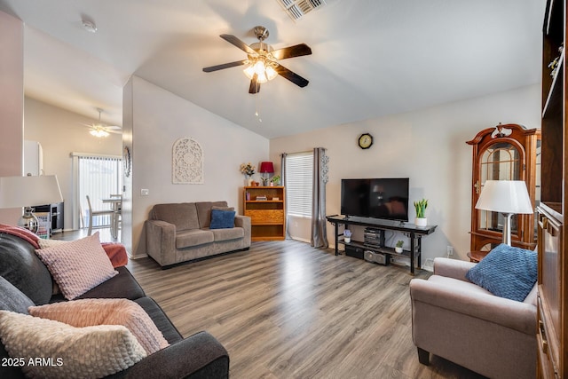 living room with lofted ceiling, ceiling fan, and light hardwood / wood-style flooring