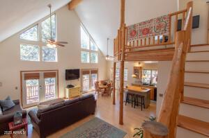 3458 N Meadow Dr, Pine, AZ 85544 - living area featuring french doors, high vaulted ceiling, a ceiling fan, beamed ceiling, and stairs
