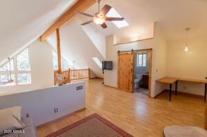 3458 N Meadow Dr, Pine, AZ 85544 - additional living space featuring ceiling fan, light wood-style floors, and a skylight
