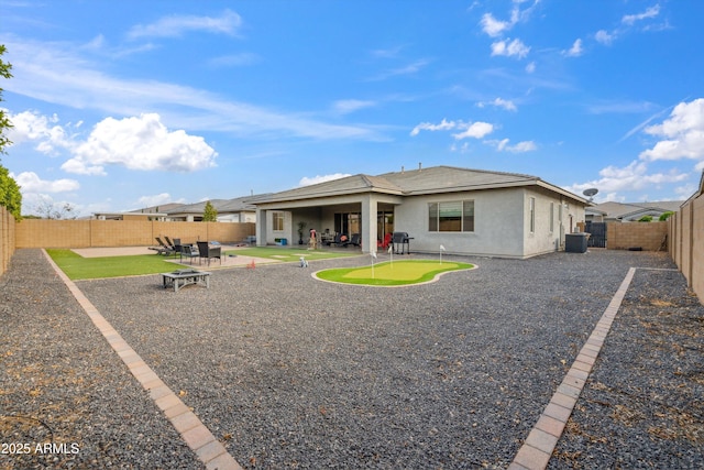 23060 E Sonoqui Blvd, Queen Creek, AZ 85142 - back of property featuring stucco siding, a patio, a fenced backyard, and a putting green