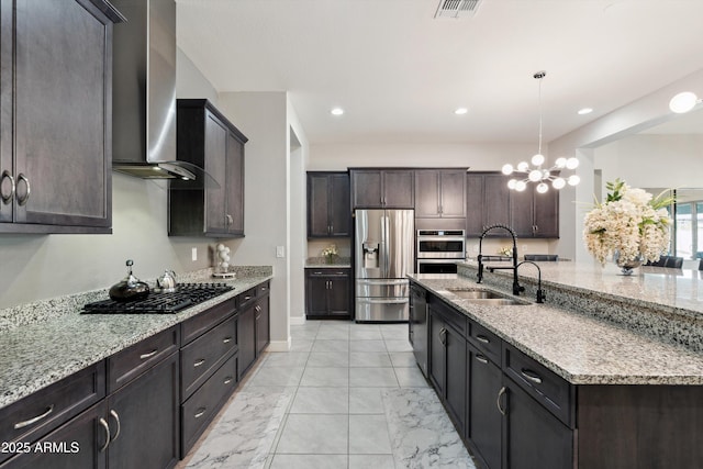 23060 E Sonoqui Blvd, Queen Creek, AZ 85142 - kitchen with appliances with stainless steel finishes, wall chimney exhaust hood, a chandelier, light stone countertops, and dark brown cabinetry