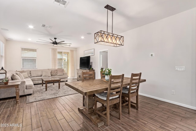 dining room with wood finished floors, visible vents, and ceiling fan