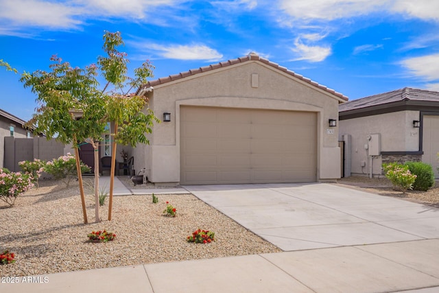 single story home with driveway, fence, a tiled roof, an attached garage, and stucco siding