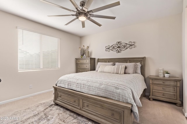 bedroom with ceiling fan, light colored carpet, and baseboards
