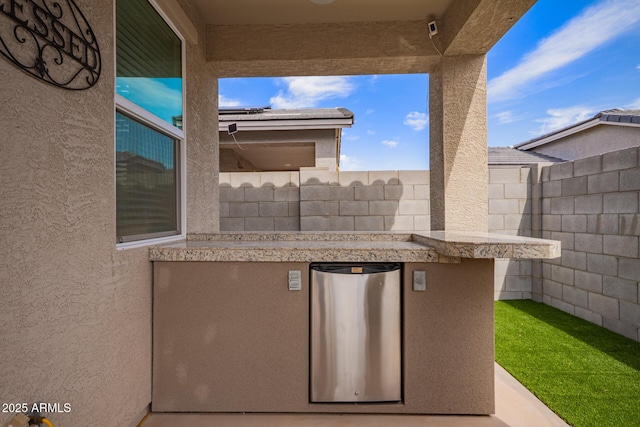 view of patio / terrace featuring fence
