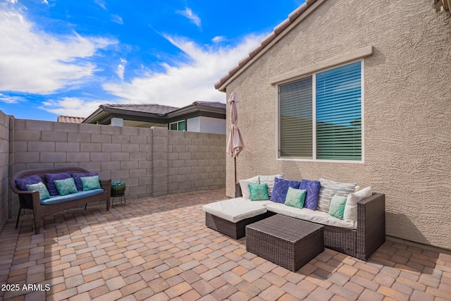 view of patio / terrace featuring an outdoor hangout area and fence