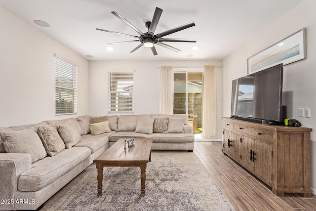 living room with baseboards, recessed lighting, ceiling fan, and light wood finished floors