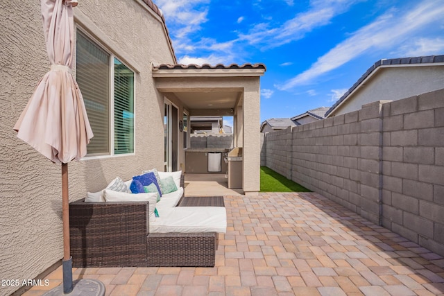 view of patio featuring an outdoor hangout area and a fenced backyard