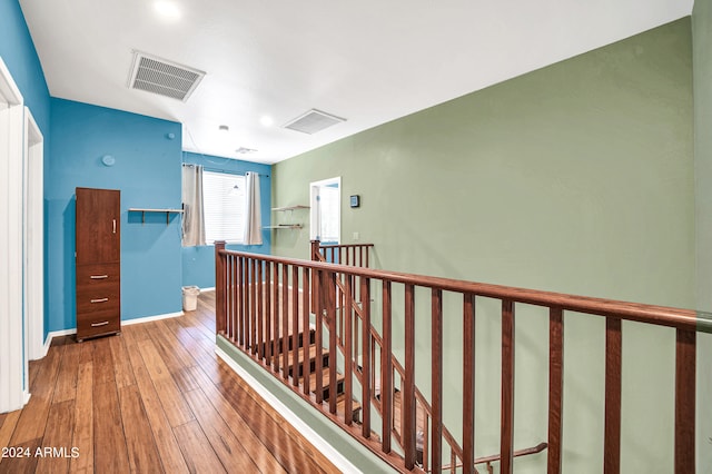 corridor with hardwood / wood-style floors