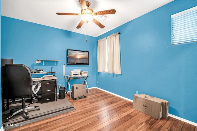 home office featuring light hardwood / wood-style floors and ceiling fan