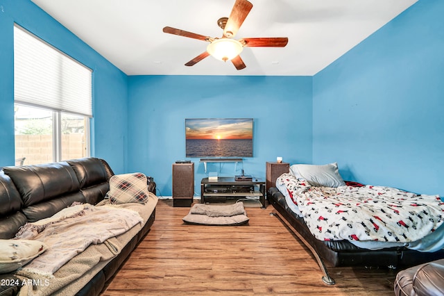 bedroom with ceiling fan and hardwood / wood-style flooring