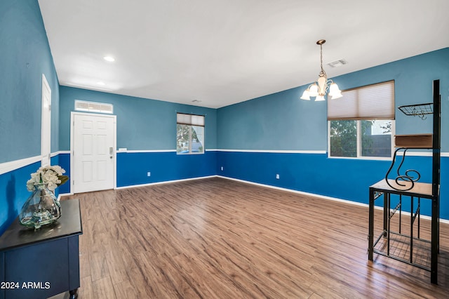 sitting room featuring hardwood / wood-style flooring, a chandelier, and a wealth of natural light