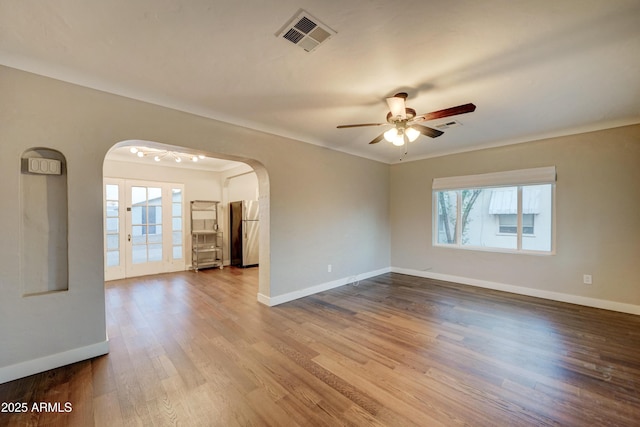 spare room with wood-type flooring and ceiling fan