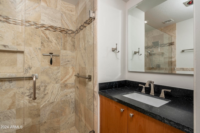 bathroom with walk in shower and vanity