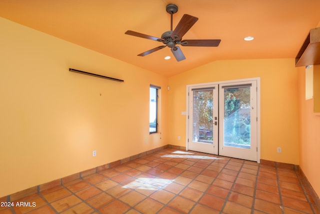 spare room featuring vaulted ceiling, ceiling fan, and light tile patterned floors