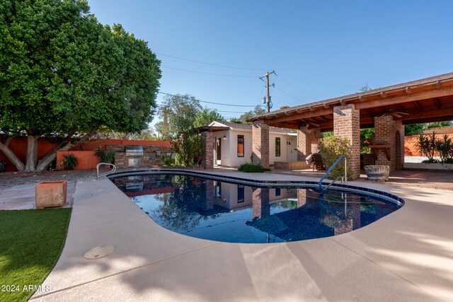 view of swimming pool featuring ceiling fan and a patio area