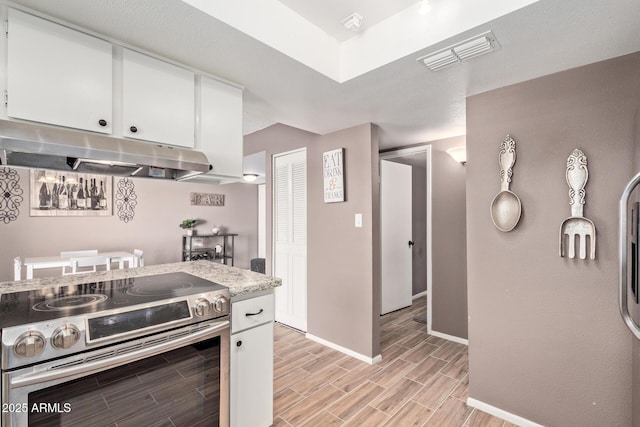 kitchen with stainless steel range with electric cooktop and white cabinets