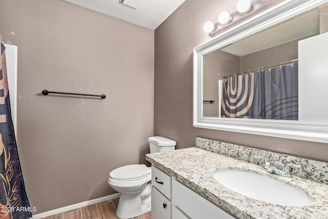 bathroom with vanity, wood-type flooring, and toilet