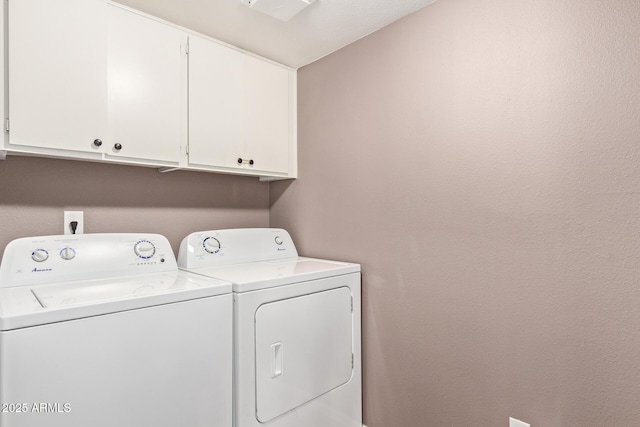 washroom with independent washer and dryer and cabinets