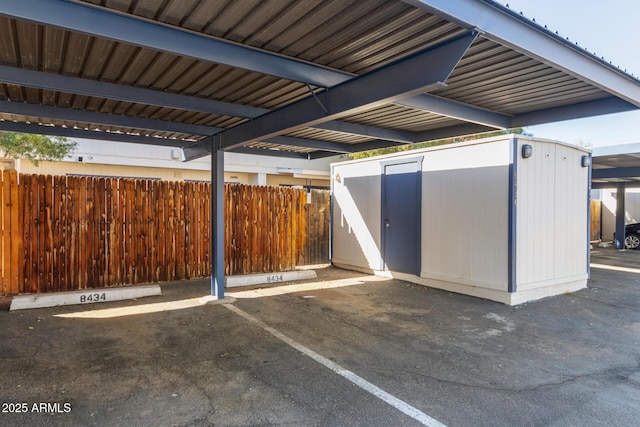 view of patio / terrace with a shed and a carport