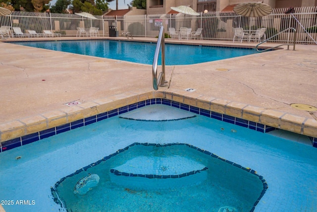 view of pool featuring a community hot tub