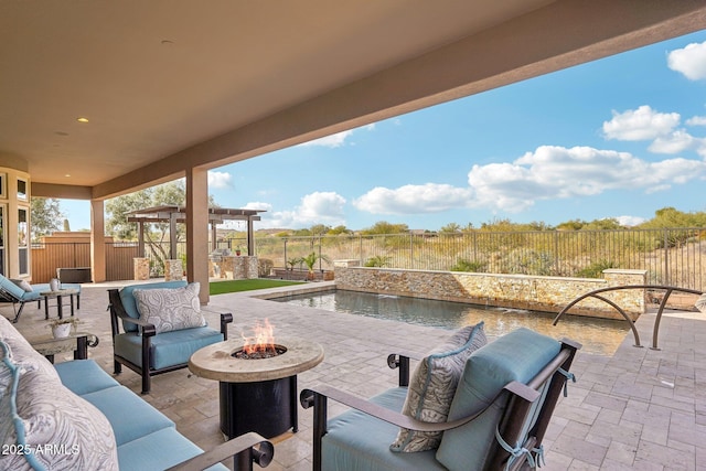 view of patio / terrace with pool water feature and an outdoor living space with a fire pit