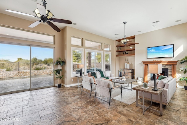 living room featuring built in shelves and ceiling fan