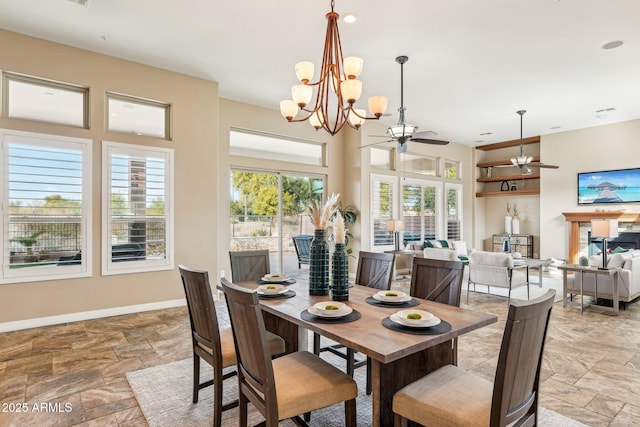 dining room featuring ceiling fan with notable chandelier