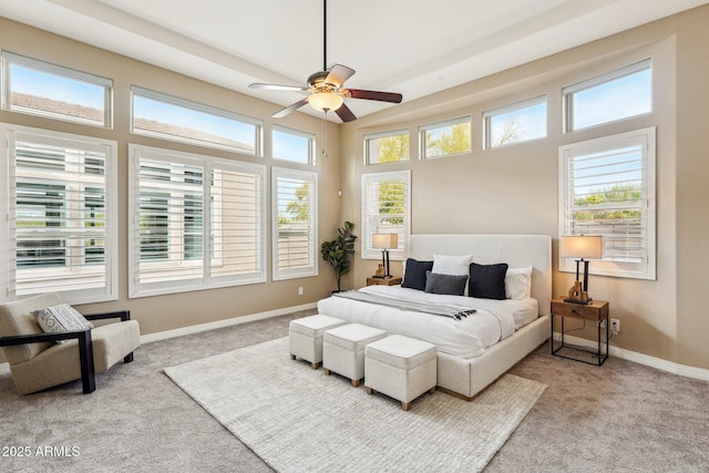 carpeted bedroom featuring multiple windows and ceiling fan